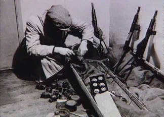 Боец движения Сопротивления разгружает сброшенный английским самолетом контейнер.